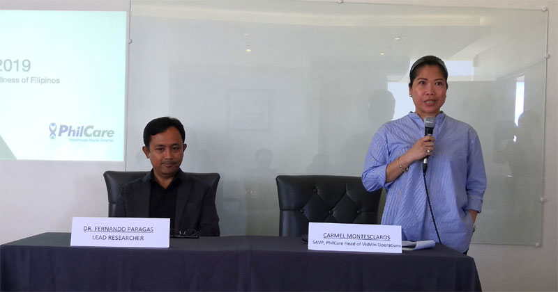 Dr. Fernando Paragas (seated), Lead Researcher of 2019 Philcare Wellness Index, and Ms. Carmel Montesclaros, SAVP and Philcare Head of VisMin Operations.