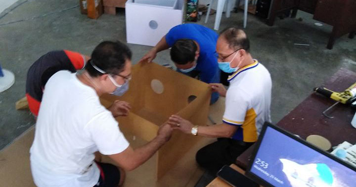 Dr. Raul Muyong of ISAT-U helps in making aerosol box for frontliners.